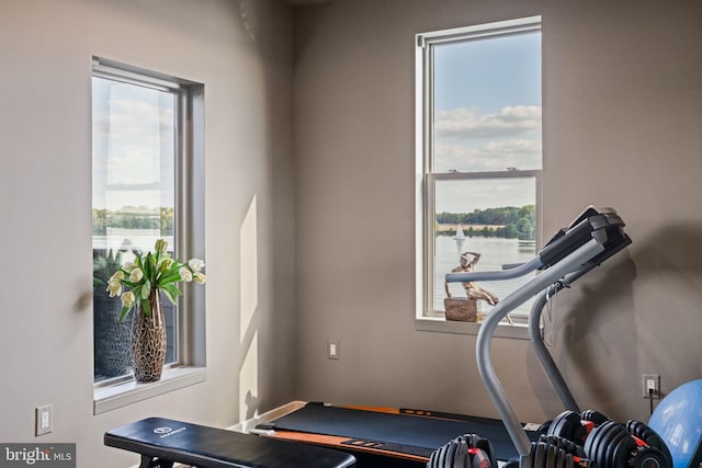 exercise area featuring a water view