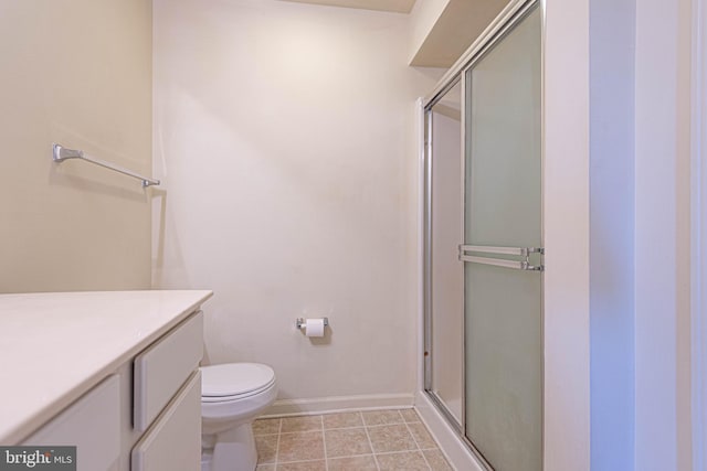 bathroom with vanity, walk in shower, toilet, and tile patterned floors