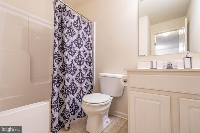 full bathroom featuring vanity, shower / bath combo with shower curtain, toilet, and tile patterned flooring