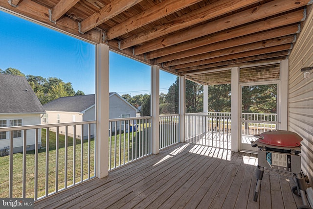 wooden terrace featuring a yard and area for grilling