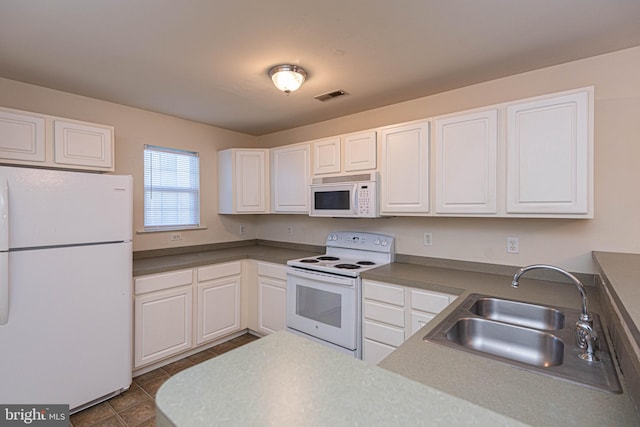 kitchen featuring white cabinetry, sink, tile patterned floors, and white appliances