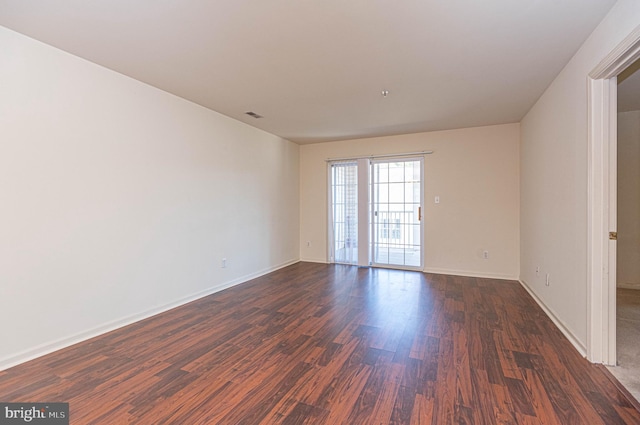 unfurnished room with dark hardwood / wood-style floors