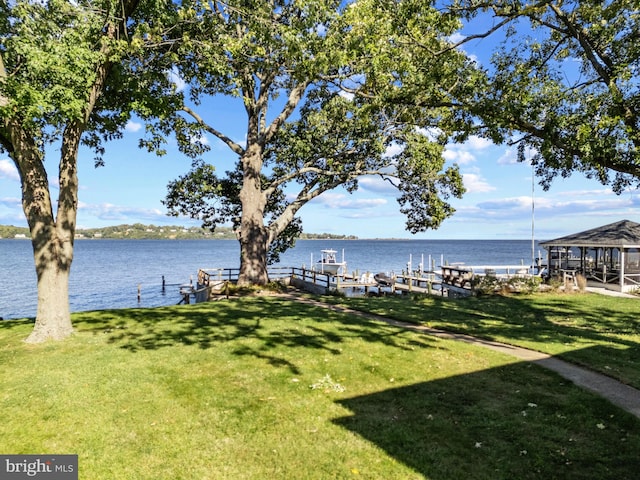 view of yard featuring a water view and a boat dock