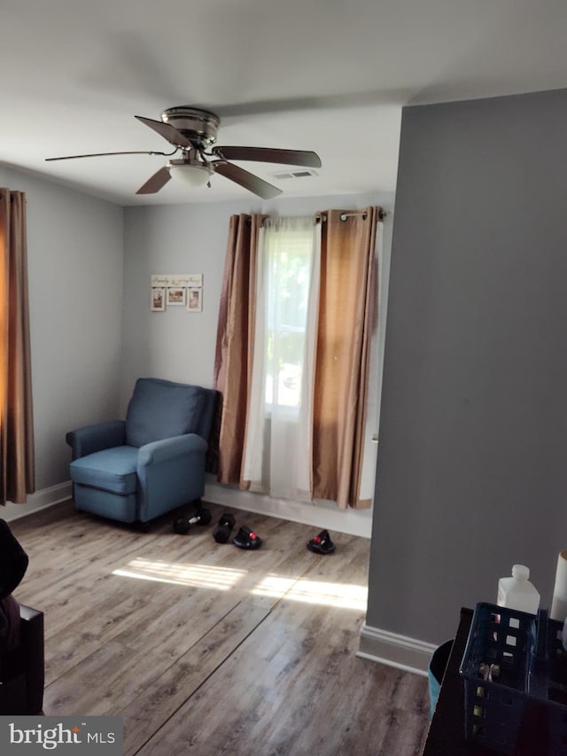 living area featuring ceiling fan and light wood-type flooring