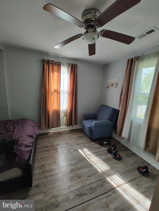 sitting room featuring hardwood / wood-style floors, a healthy amount of sunlight, and ceiling fan