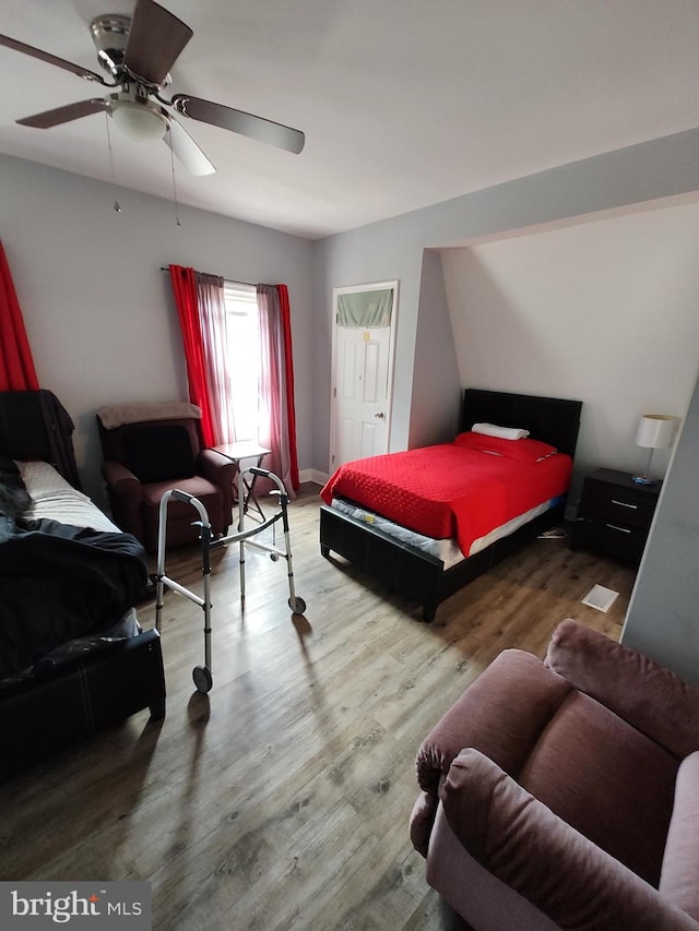 bedroom featuring wood-type flooring and ceiling fan