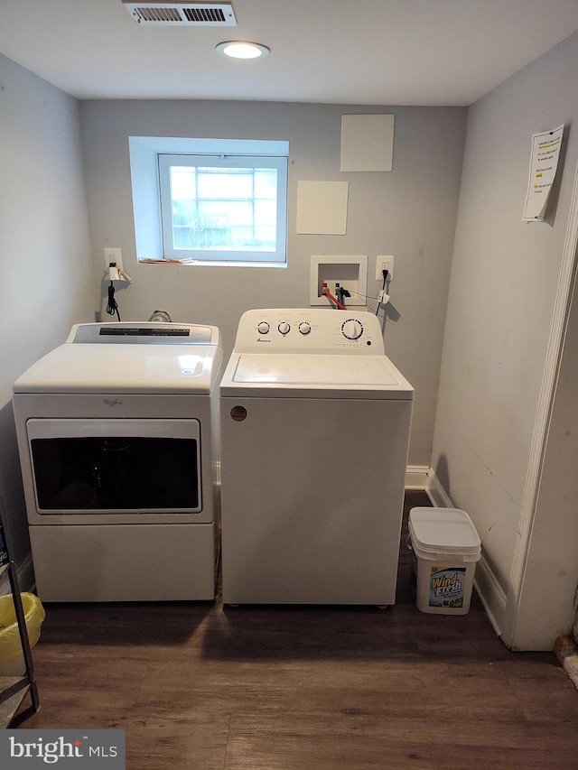 washroom with dark hardwood / wood-style floors and independent washer and dryer