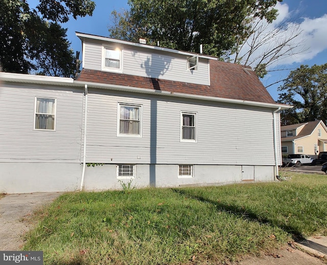 view of side of home featuring a yard