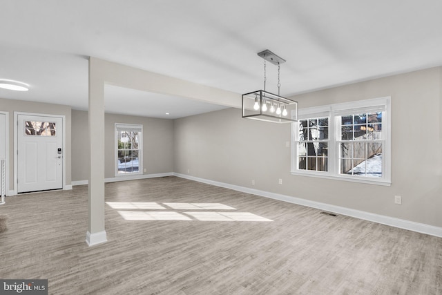 unfurnished dining area with light hardwood / wood-style flooring