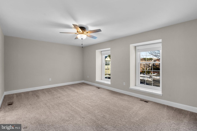 carpeted empty room featuring ceiling fan