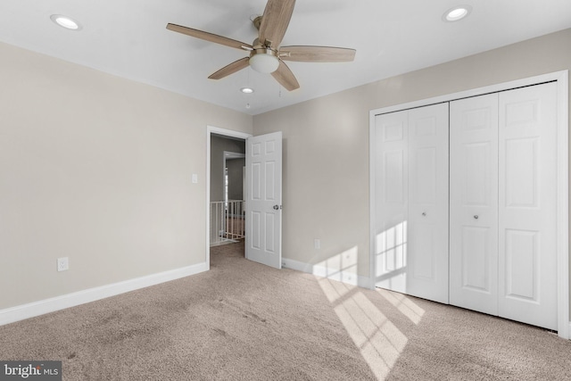 unfurnished bedroom with light colored carpet, ceiling fan, and a closet