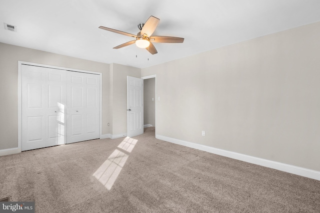 unfurnished bedroom featuring a closet, carpet floors, and ceiling fan