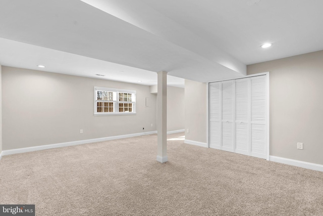 basement featuring light carpet