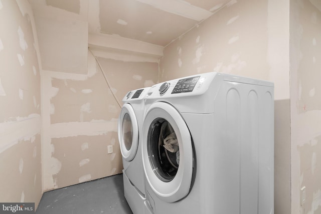 clothes washing area featuring washer and clothes dryer