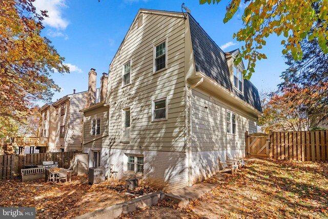 view of side of home with central AC unit