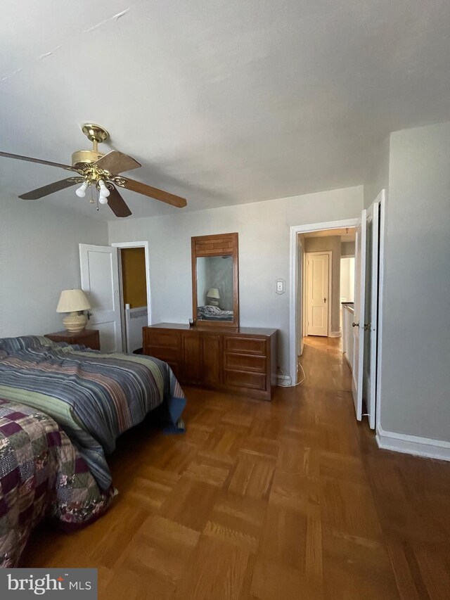 bedroom featuring ceiling fan and parquet floors