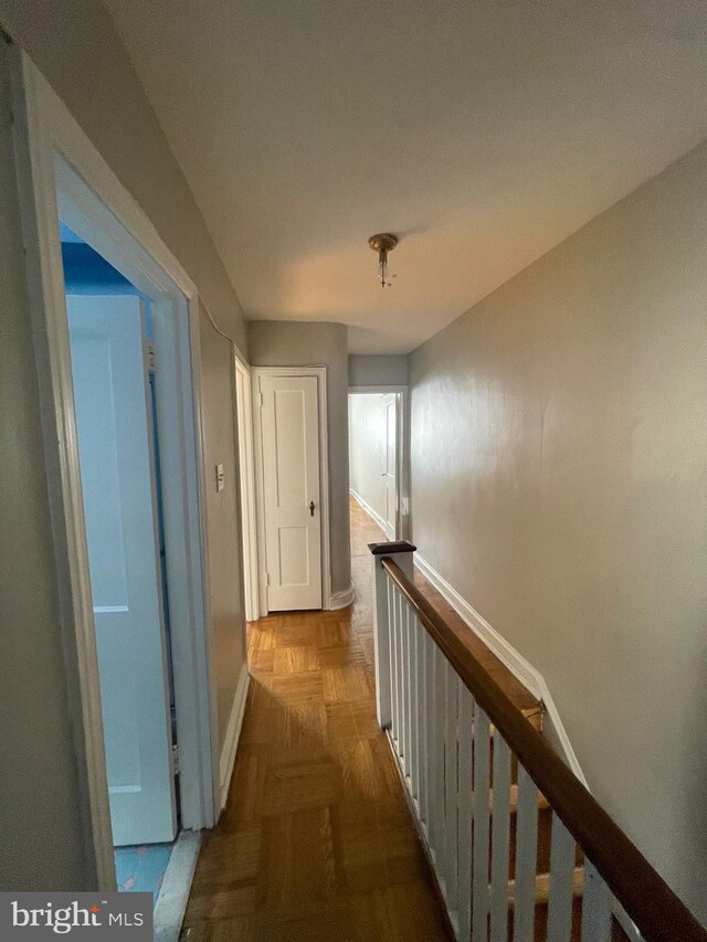 corridor featuring light parquet flooring