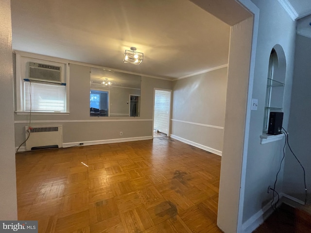 empty room featuring parquet flooring, crown molding, radiator, and a wall mounted AC