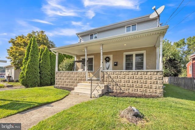 view of front of property featuring a front lawn and covered porch