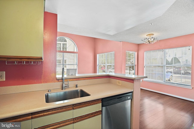 kitchen with dark hardwood / wood-style flooring, a notable chandelier, sink, dishwasher, and a textured ceiling