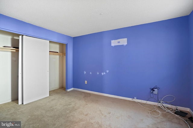 unfurnished bedroom featuring a closet and light carpet