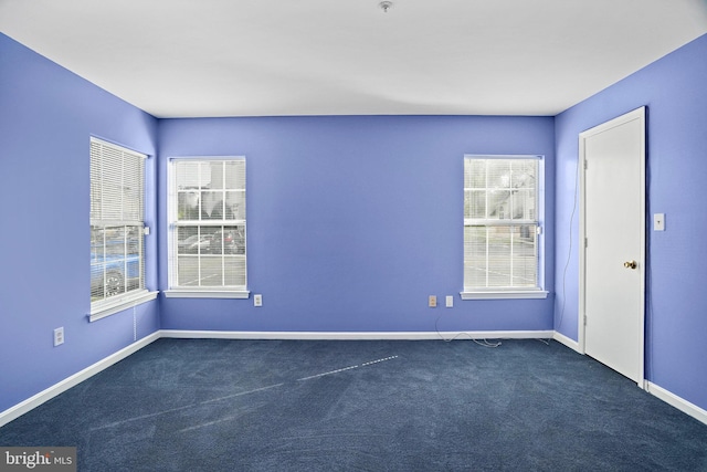 carpeted spare room with a healthy amount of sunlight