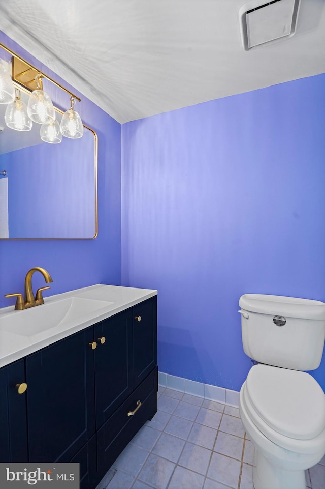 bathroom with vanity, toilet, and tile patterned floors