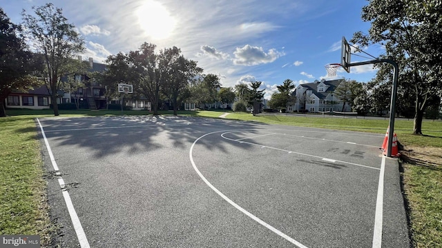 view of sport court with a yard