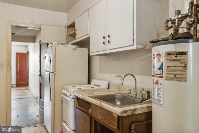 kitchen with white appliances, light tile patterned flooring, sink, water heater, and white cabinetry