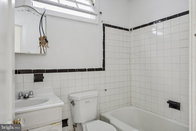 bathroom with toilet, vanity, and tile walls