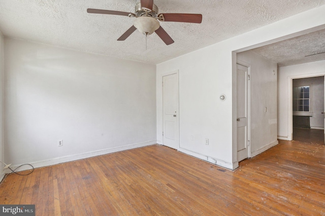 unfurnished room featuring a textured ceiling, hardwood / wood-style floors, and ceiling fan