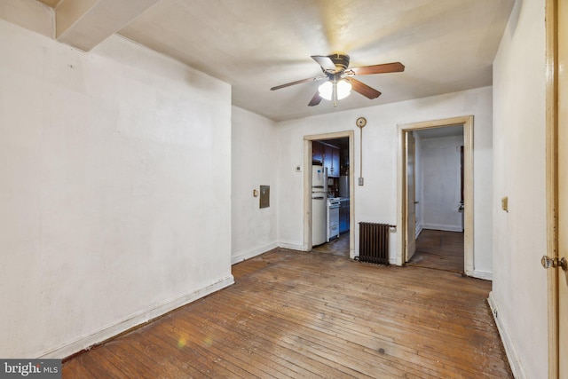 unfurnished room with hardwood / wood-style floors, radiator heating unit, and ceiling fan