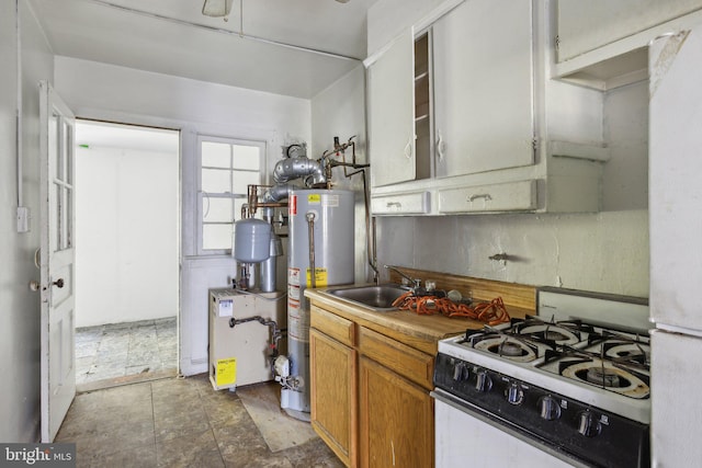 kitchen featuring water heater, sink, and white appliances