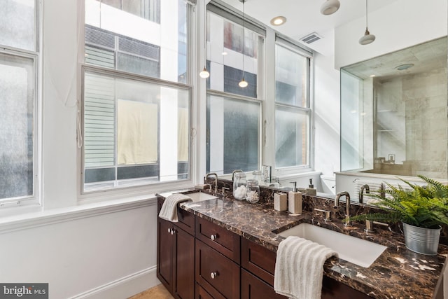 bathroom with plenty of natural light and vanity