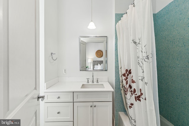 bathroom featuring vanity and shower / tub combo with curtain