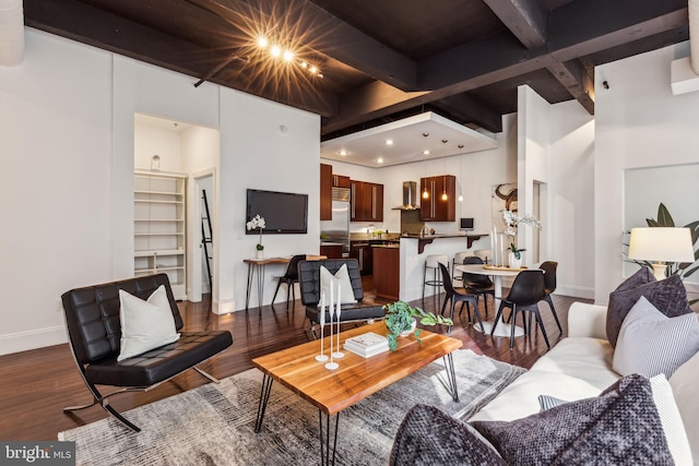 living room featuring beamed ceiling and dark hardwood / wood-style floors