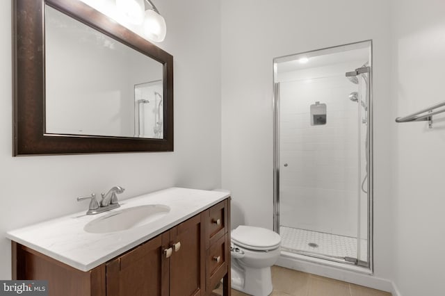 bathroom featuring vanity, tile patterned flooring, toilet, and a shower with door