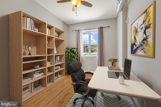 home office featuring light hardwood / wood-style flooring and ceiling fan