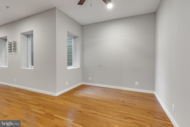 empty room with light hardwood / wood-style floors and ceiling fan