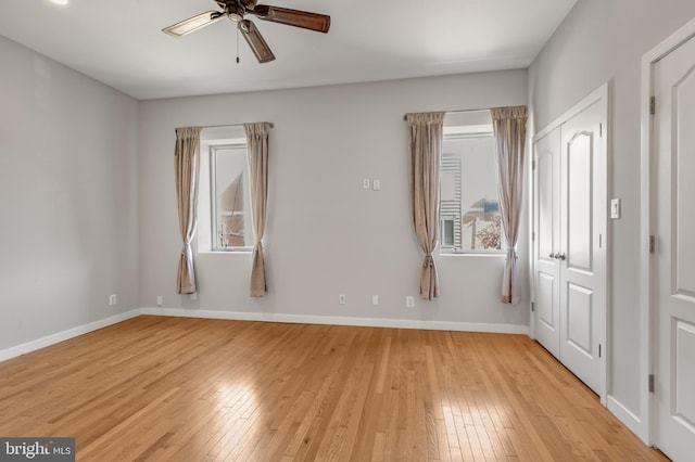 empty room featuring ceiling fan and light hardwood / wood-style flooring