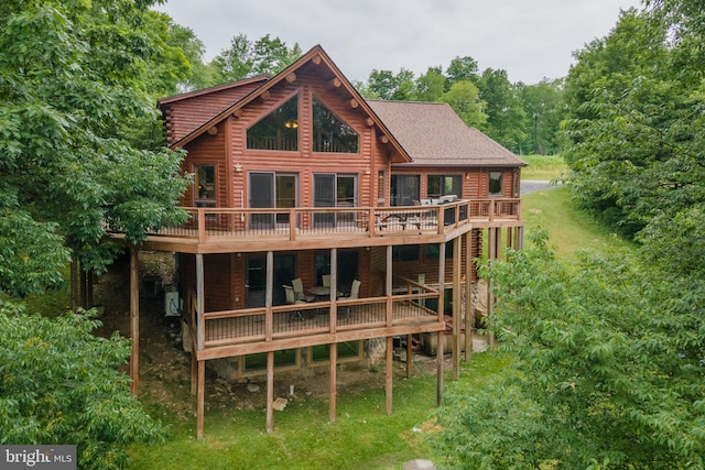 back of house with a deck