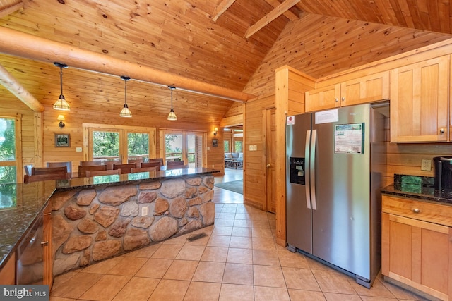 kitchen featuring dark stone counters, wood walls, stainless steel refrigerator with ice dispenser, wood ceiling, and hanging light fixtures