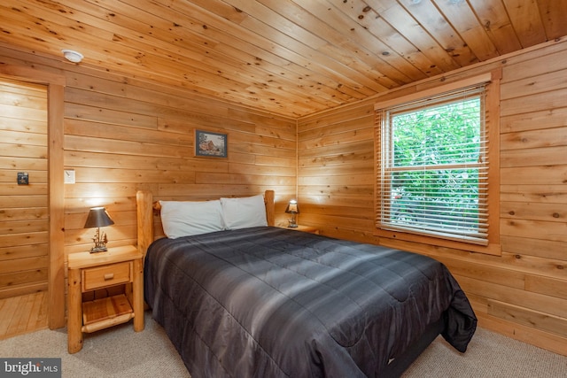 bedroom featuring wood walls, light colored carpet, and wood ceiling