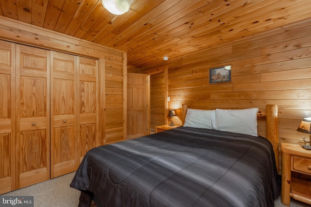 bedroom featuring wooden walls, a closet, wood ceiling, and carpet