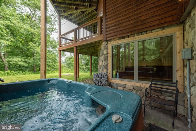 view of pool with a hot tub and a wooden deck