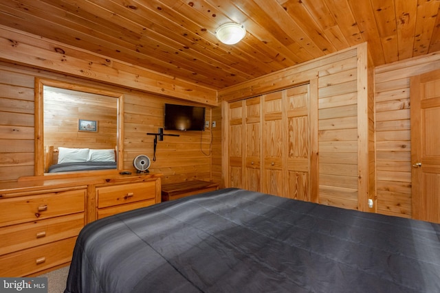 unfurnished bedroom with wooden ceiling, wooden walls, and a closet