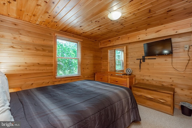 carpeted bedroom with wooden walls and wood ceiling