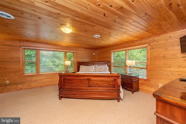 bedroom featuring wood walls, light carpet, and wooden ceiling