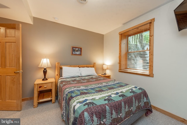 carpeted bedroom featuring lofted ceiling