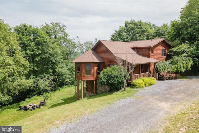 log-style house with a front lawn